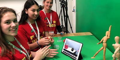 Three students at Gippsland Tech School demonstrate how augmented reality technology works on an iPad.