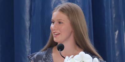 A photo of Tamsyn Lovass, including her head and shoulders, looking to the side of the camera