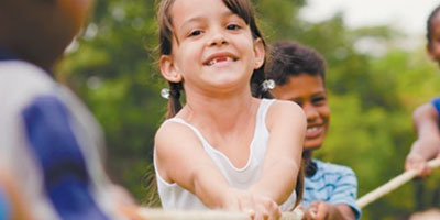 Small girl smiling with other children